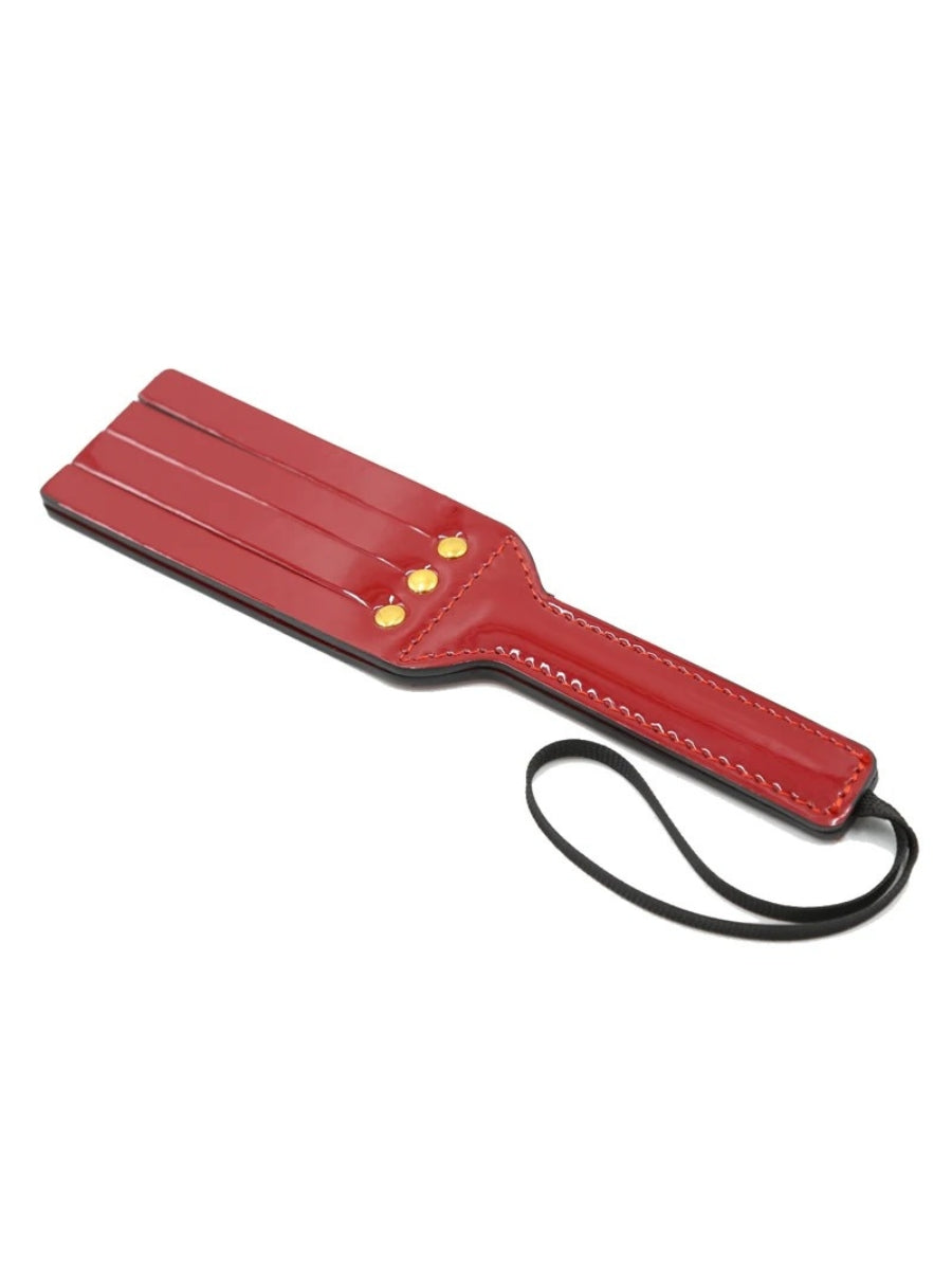 Red Glossy Faux Leather Paddle with Wrist Loop and Gold-Tone Stud Details